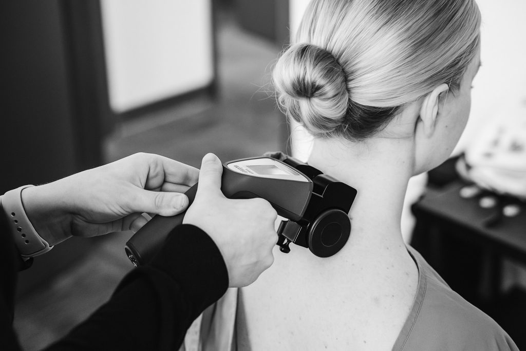 Woman receiving spinal scan treatment.