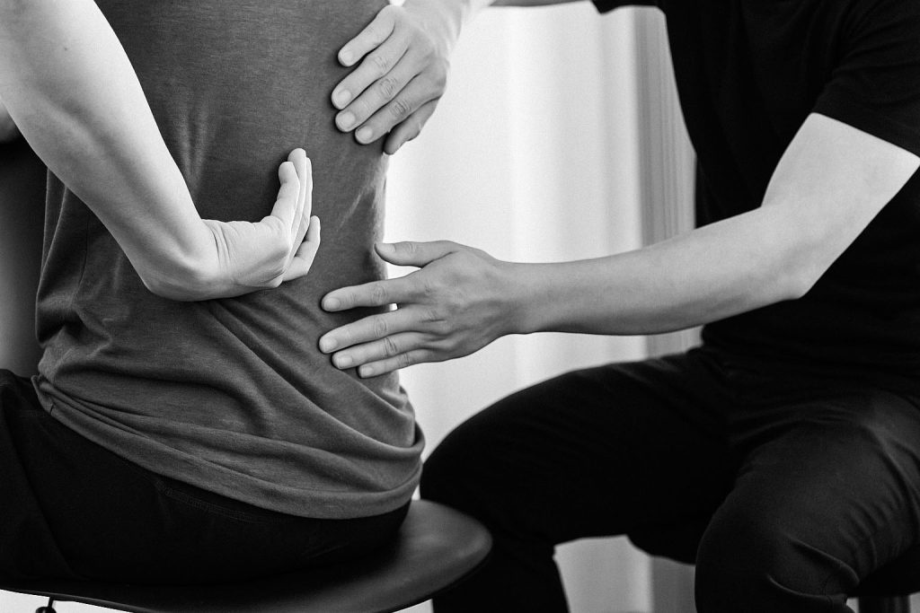Two people assessing back alignment