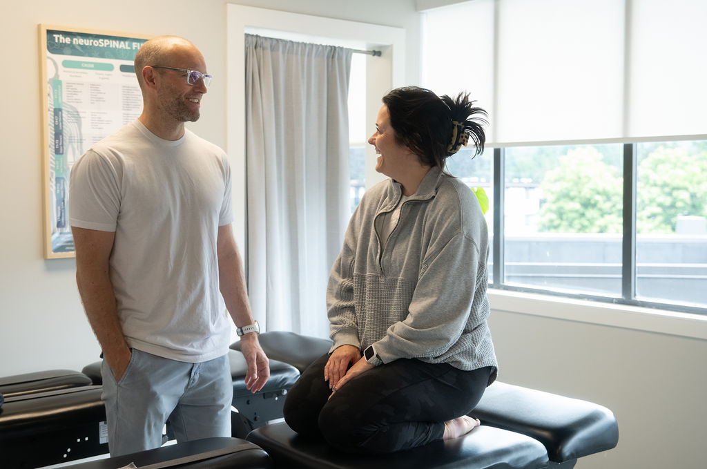 Chiropractor and patient in clinic.