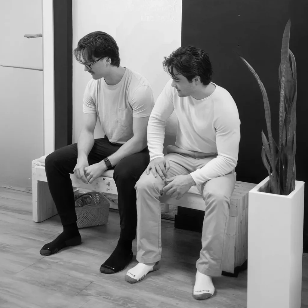 Two men sitting on benches.