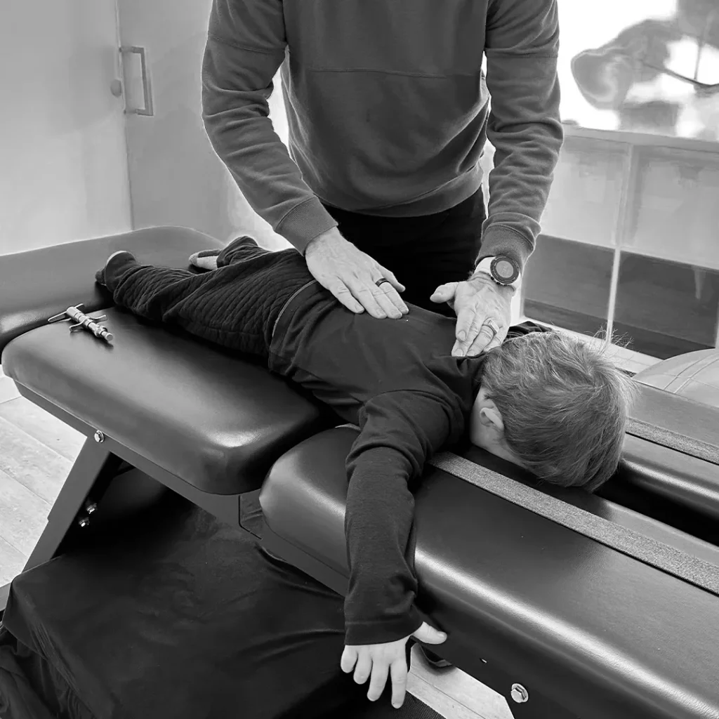 Child receiving chiropractic adjustment