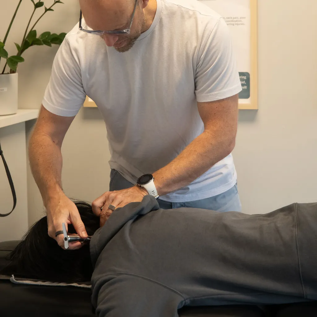 Chiropractor performing neck adjustment