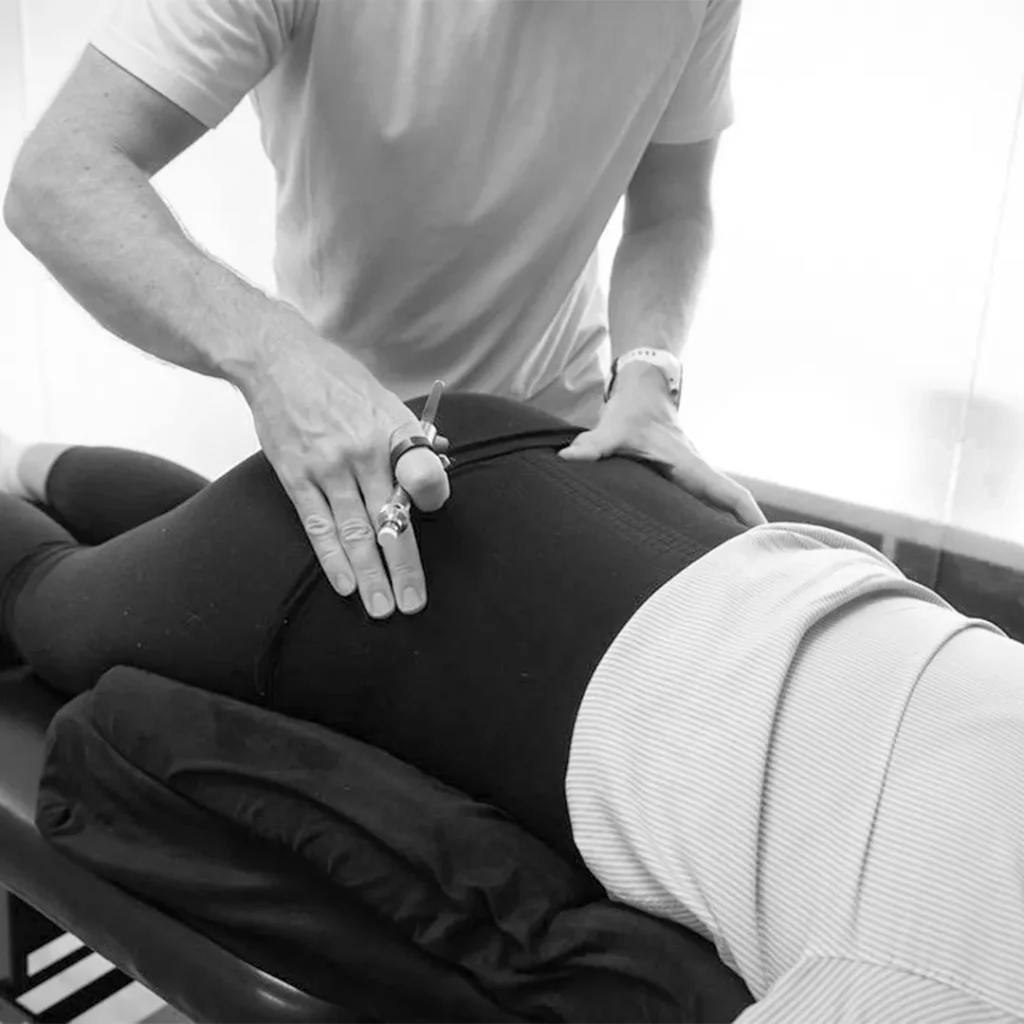 Chiropractor adjusting pregnant woman's back.