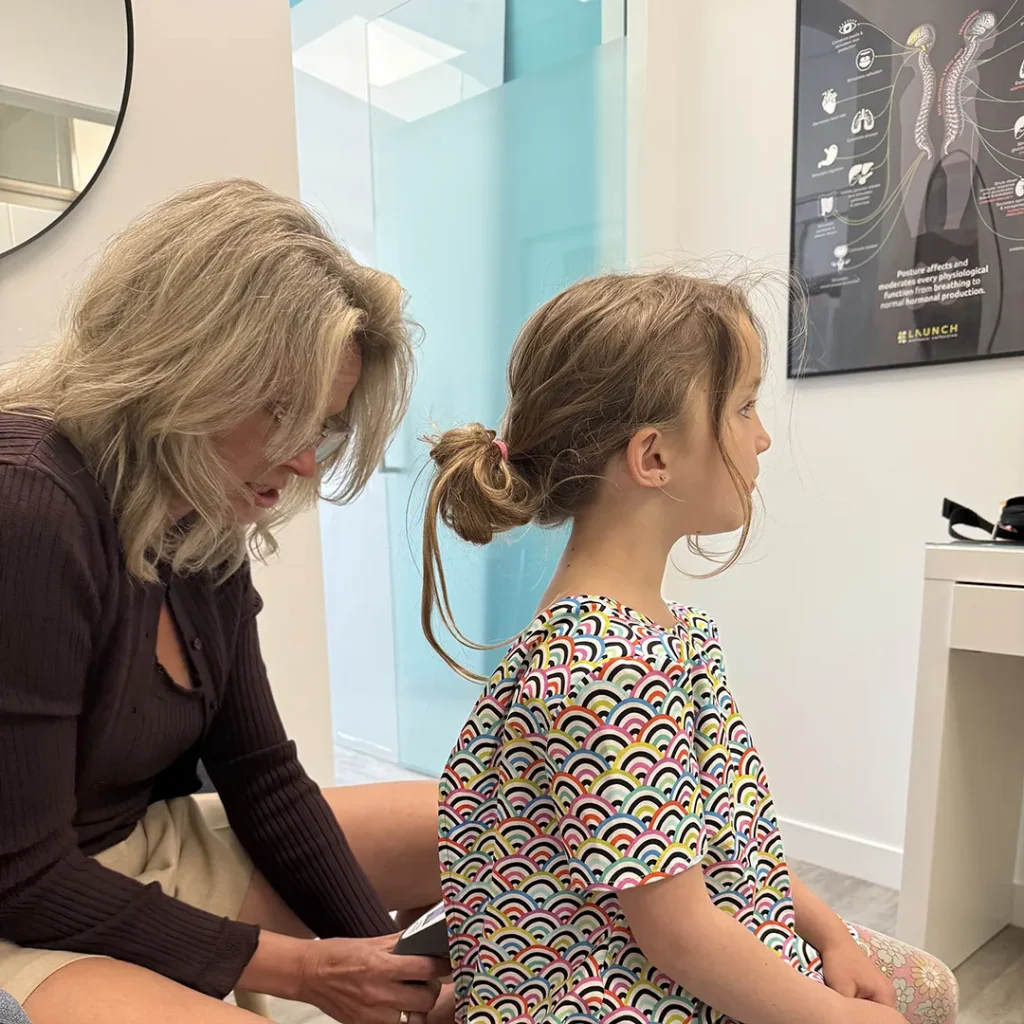 Woman performing an insight scan in clinic.