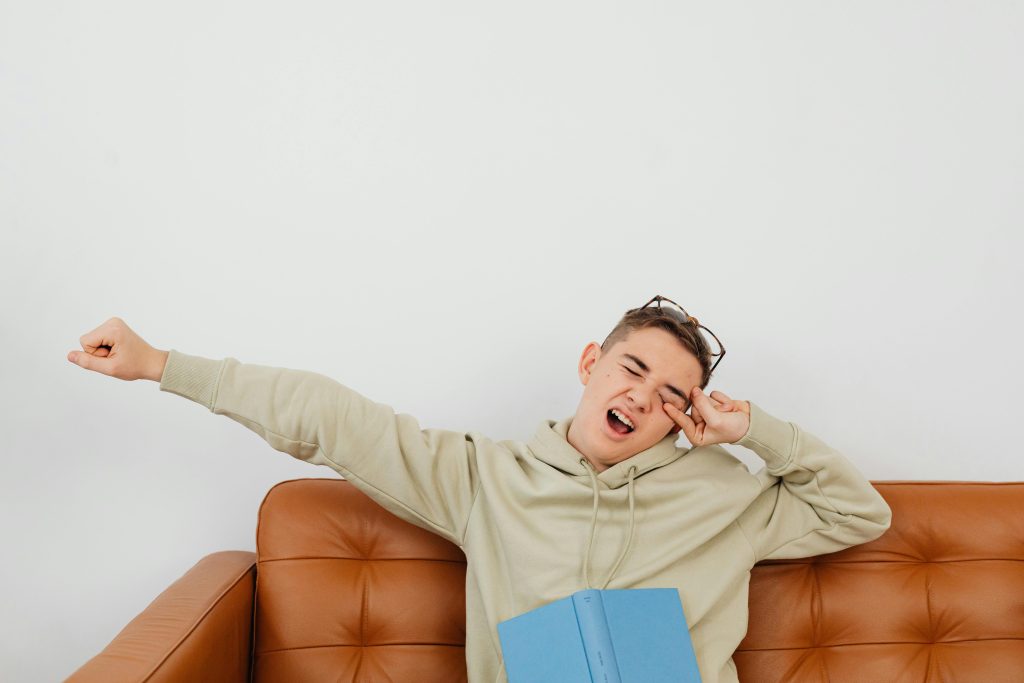 person with central nervous system fatigue yawns on a coach